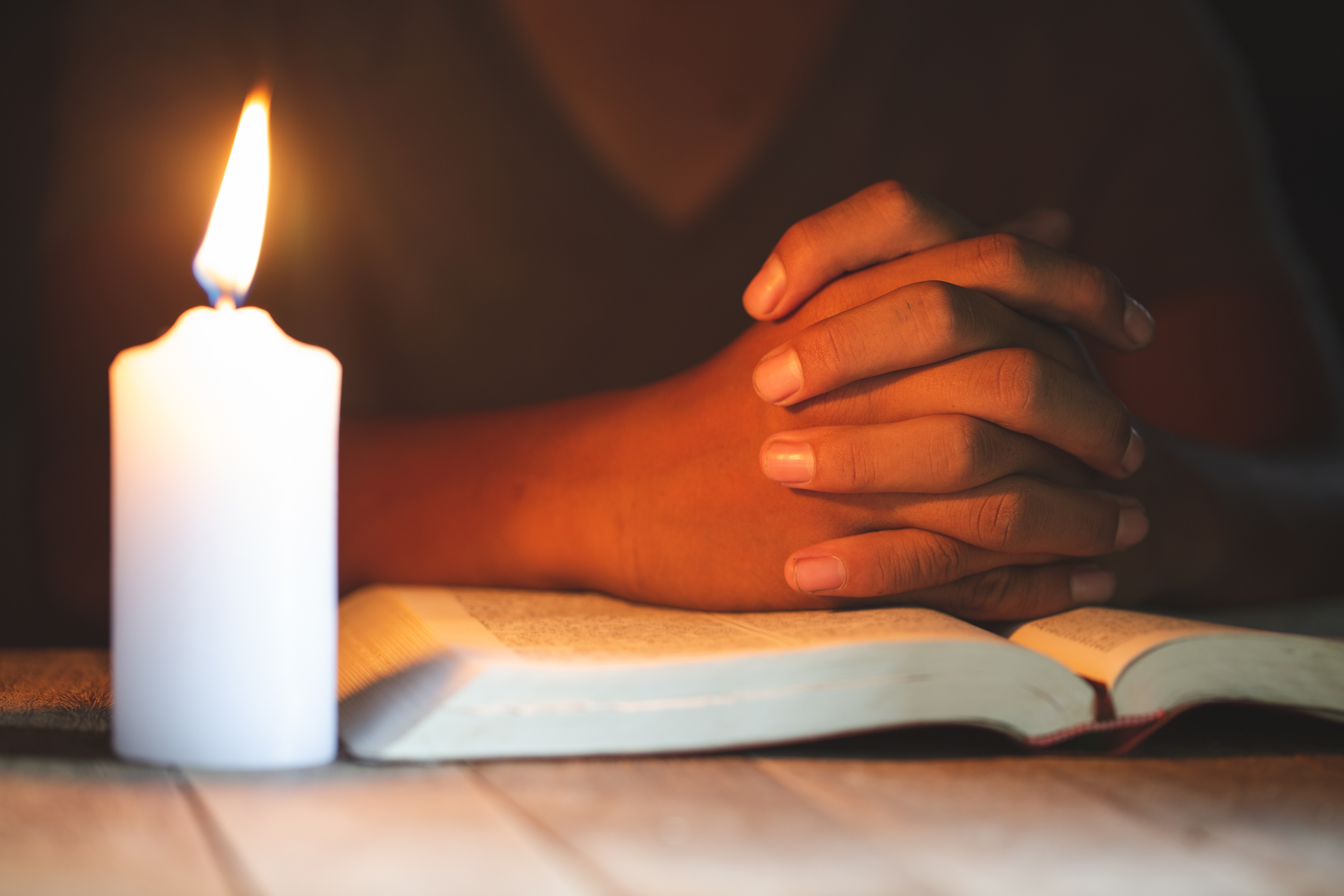 Praying and reading the Bible by candlelight